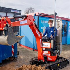 Makeathon participants on the converted hydrogen-powered excavator