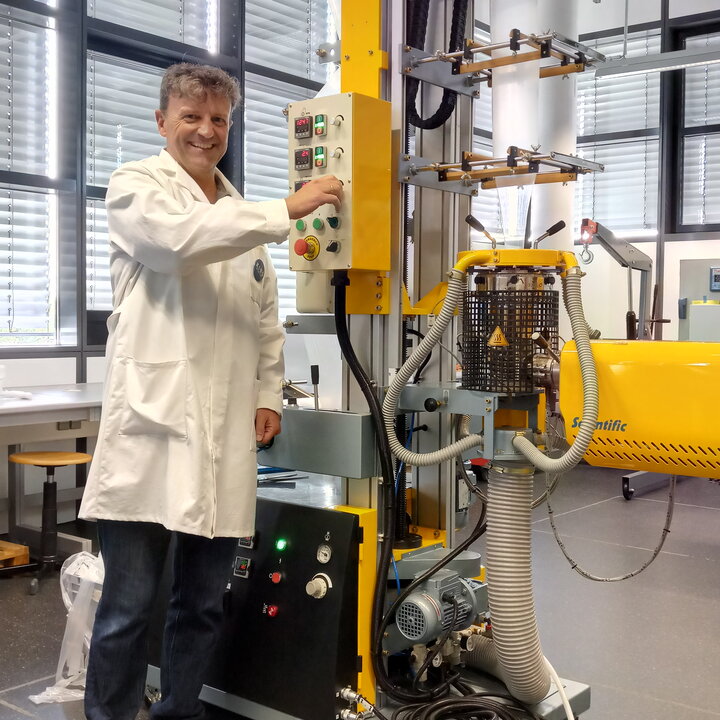 Professor working on a machine at the Plastics Technology Centre