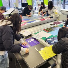 Students are working at a table in the design workshop