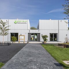 Exterior view of the Green FabLab in Kamp-Lintfort, showing the entrance area, green spaces and trees.