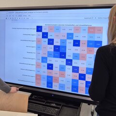 Two female students are looking at a diagram on the whiteboard in the laboratory