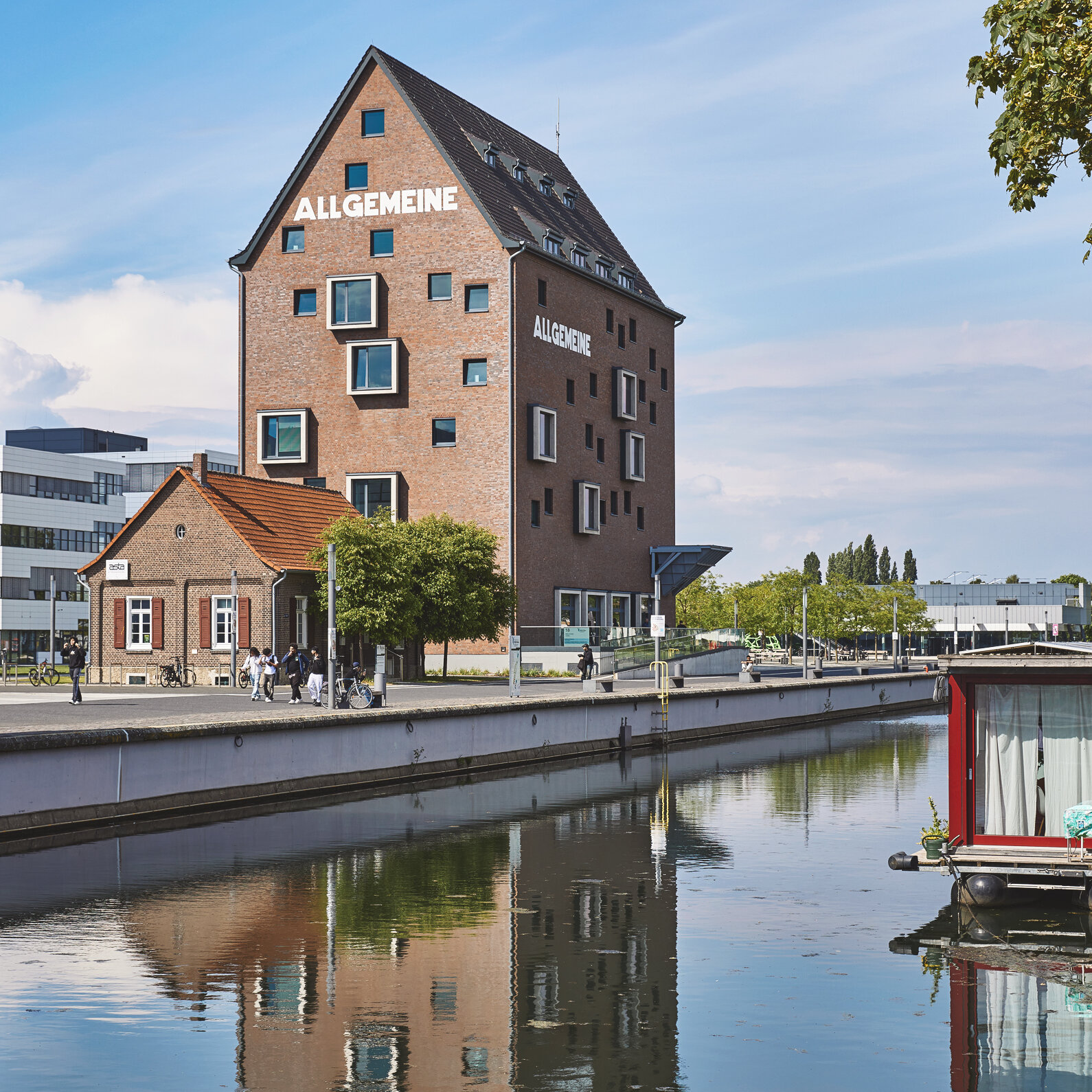 Spoy Canal, with the library building behind it; a tall brick building with a gabled roof