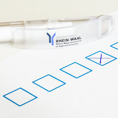 Ballpoint pens bearing the university logo on the questionnaire