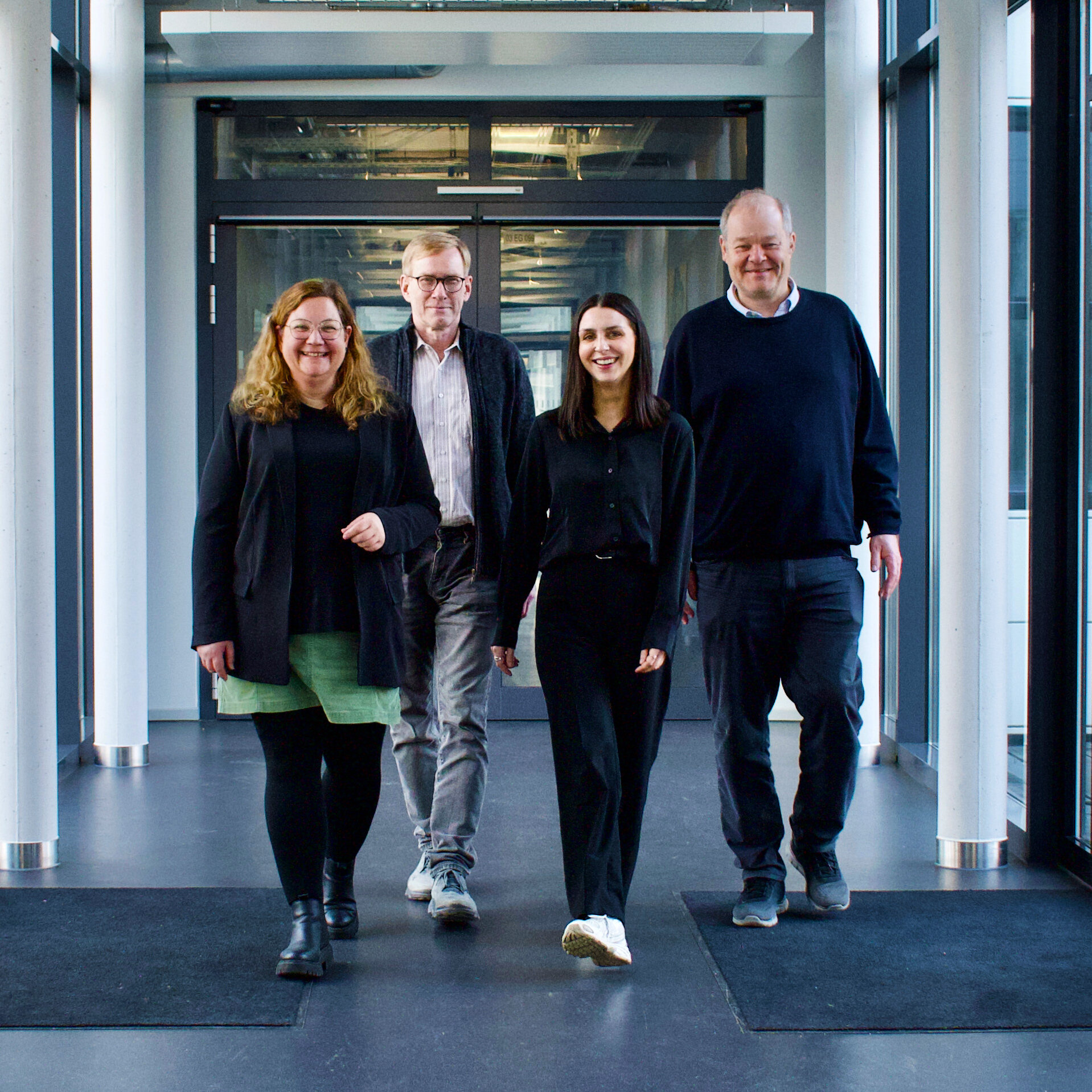 Vier Personen laufen über den Gang der Hochschule Rhein-Waal. Sie bilden das Gremium der SBV.