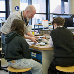 A professor and two students at the Maths Olympiad at the university