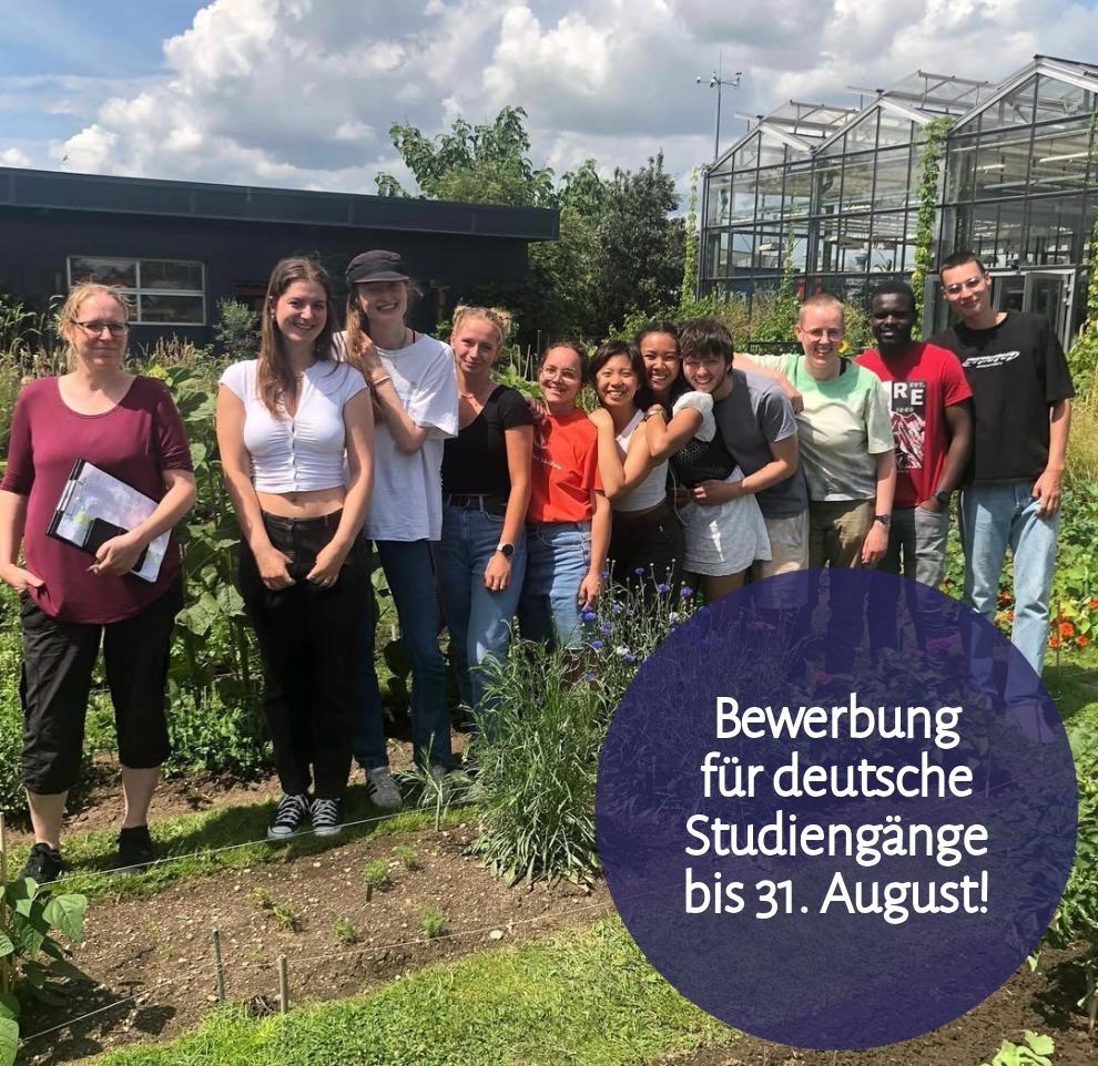 Final practical training of students, who are standing in front of of the tropical green house.